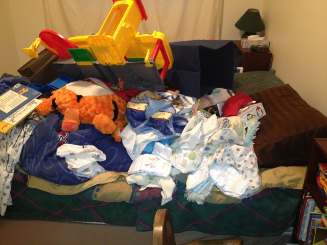 A pile of stuff on a kid's bed