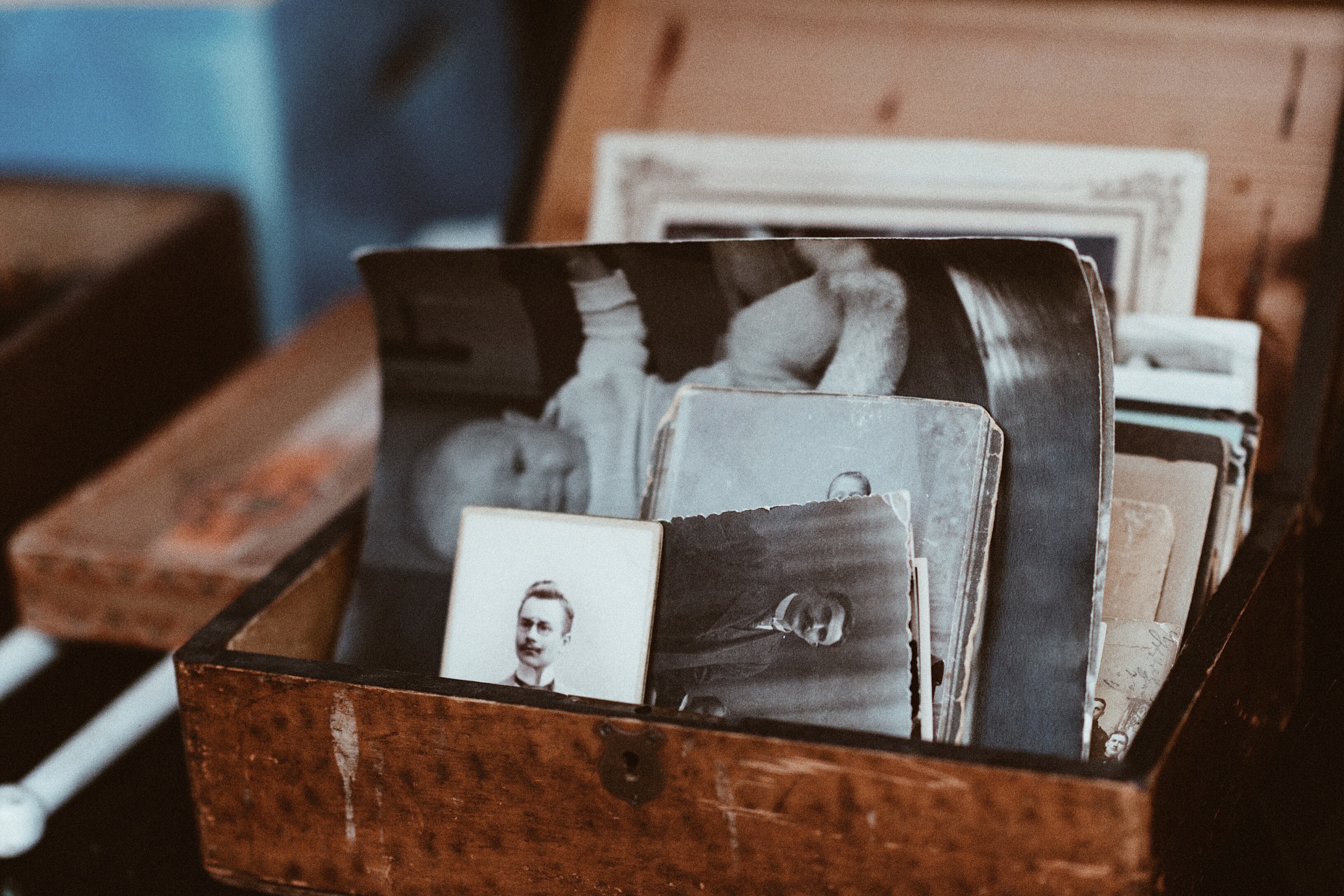 A box with old, black-and-white photos in it.