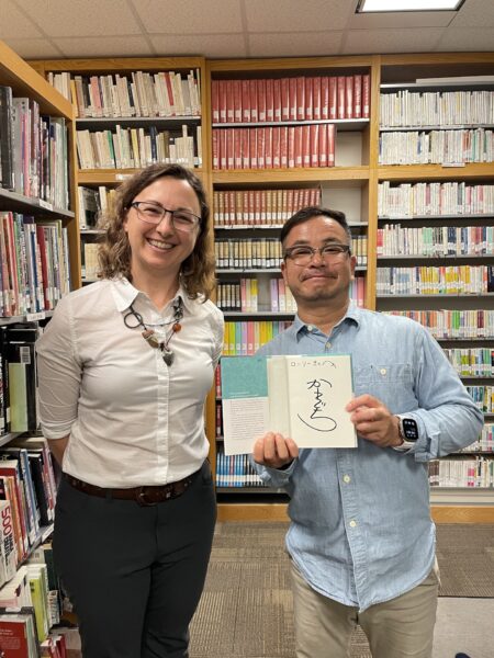 Japanese author Toshikazu Kawaguchi holds up the book he signed for Lori Wolf-Heffner at the Japan Foundation's library in Toronto.